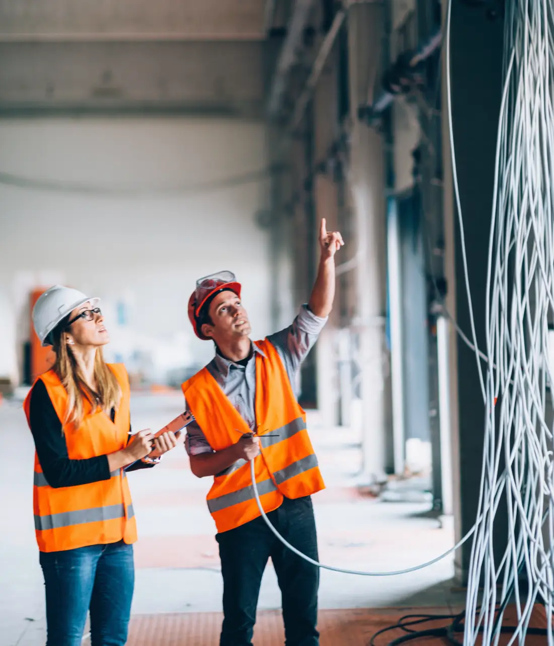 Construction workers inspect building wiring.